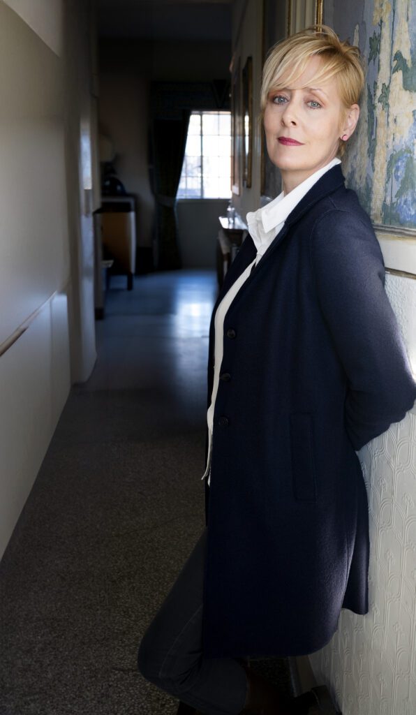 Photo of Charlotte leaning against a wall