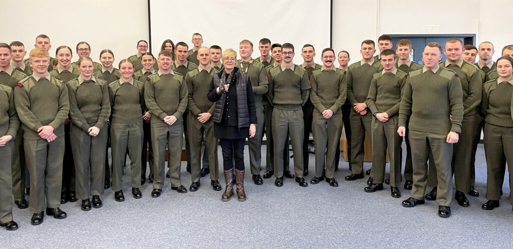 Photo of Charlotte and military personnel