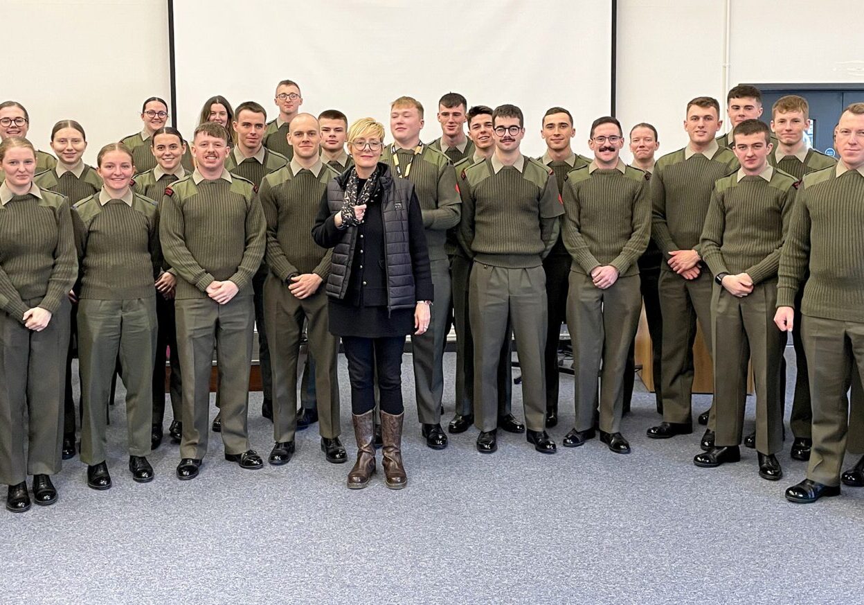 Photo of Charlotte and military personnel